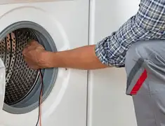 Dryer repair technician diagnosing and servicing a clothes dryer in San Jose, CA