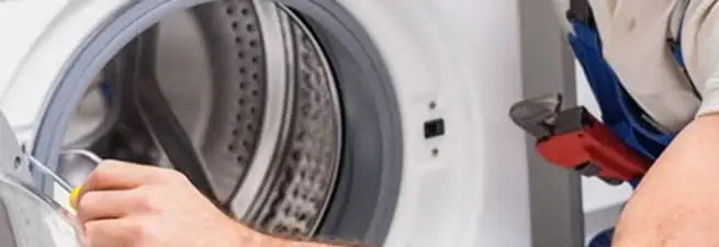Appliance technician repairing a clothes dryer drum and internal parts in San Jose, CA